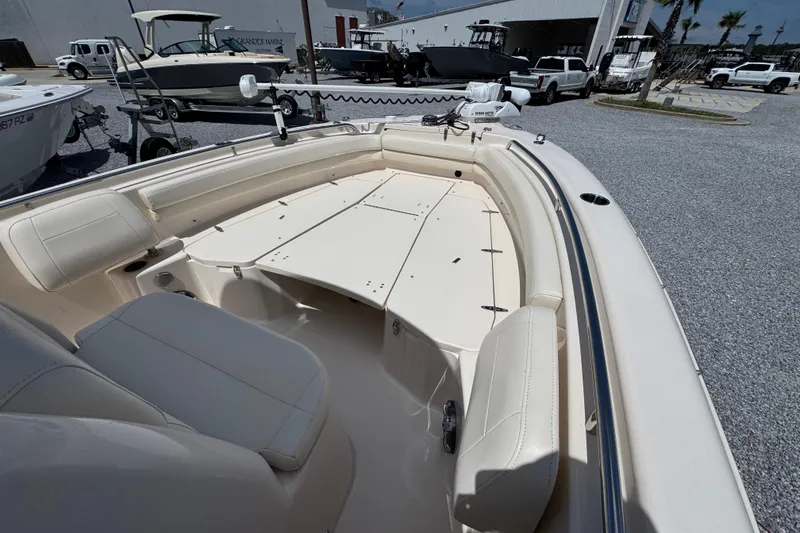 Slide: The Image of 2022 Grady-White Fisherman 257 boat interior with seating and storage, displayed outdoors. - 13