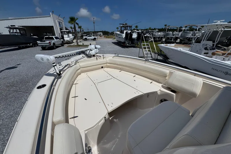 Slide: The Image of 2022 Grady-White Fisherman 257 boat displayed at a dealership, showcasing spacious seating and deck. - 15