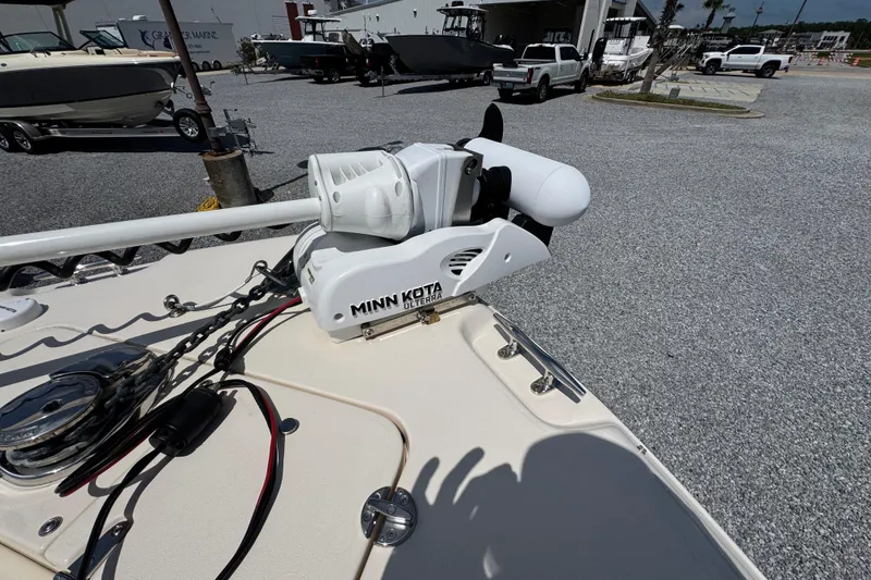 Slide: The Image of 2022 Grady-White Fisherman 257 with Minn Kota trolling motor in a marina setting. - 16