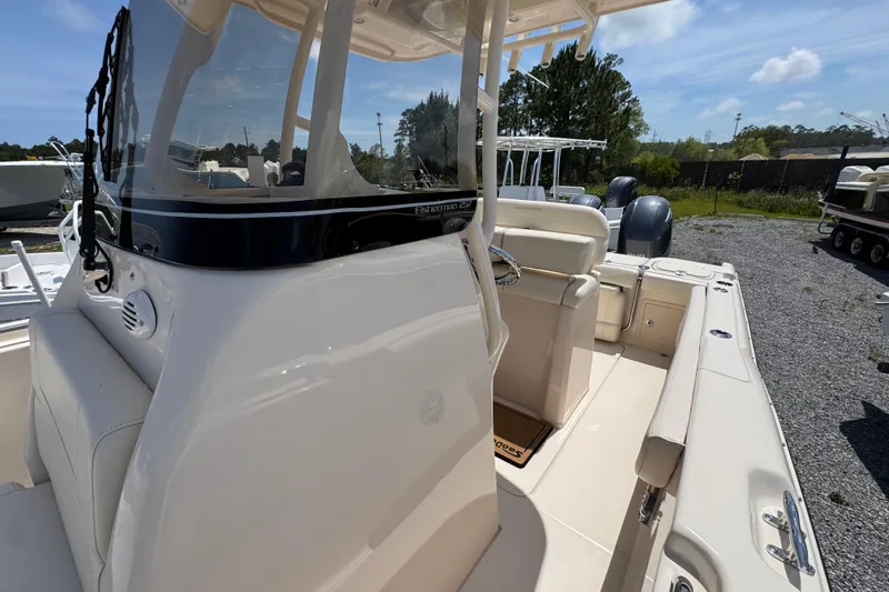 Slide: The Image of 2022 Grady-White Fisherman 257 boat interior with seating and console, parked outdoors. - 21