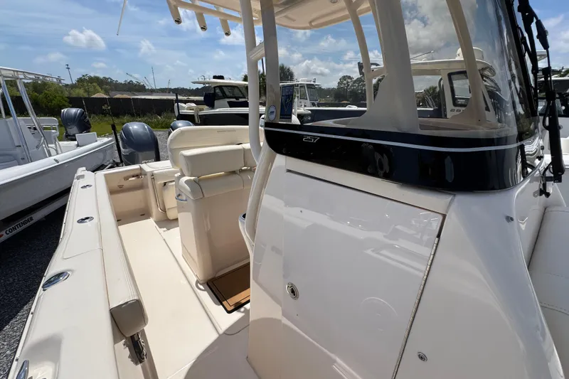 Slide: The Image of 2022 Grady-White Fisherman 257 boat interior with seating and console, docked outdoors. - 22