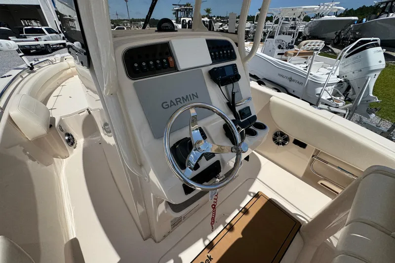 Slide: The Image of 2022 Grady-White Fisherman 257 boat cockpit with Garmin navigation system and steering wheel. - 26