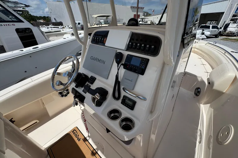 Slide: The Image of 2022 Grady-White Fisherman 257 boat dashboard with Garmin navigation system and controls. - 28