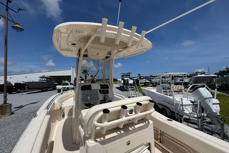 Slide: The Image of 2022 Grady-White Fisherman 257 boat, center console view, parked outdoors under blue sky. - 31