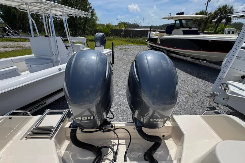 Slide: The Image of Twin Yamaha 200 engines on a 2022 Grady-White Fisherman 257 boat, parked outdoors. - 35