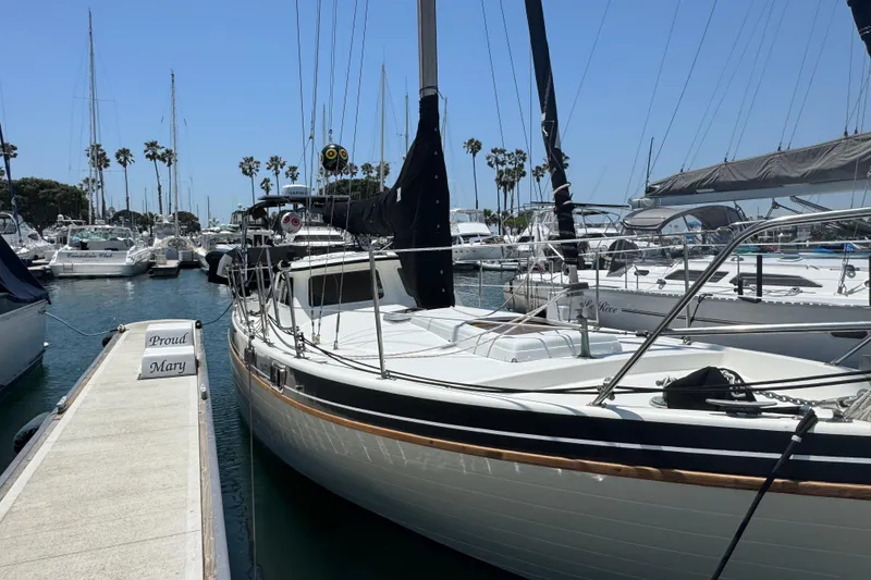 Slide: The Image of 1989 Gulf Pilot House sailboat docked at marina with clear blue sky. - 11