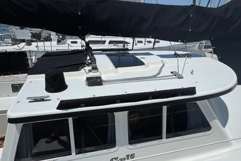 Slide: The Image of 1989 Gulf Pilot House sailboat deck with black sail cover and rigging. - 13