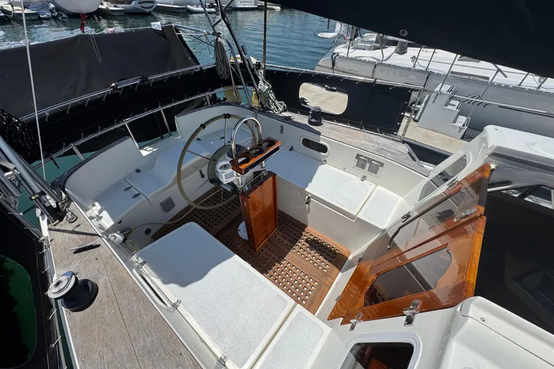 Slide: The Image of 1989 Gulf Pilot House yacht cockpit with steering wheel, wooden accents, and marina view. - 16