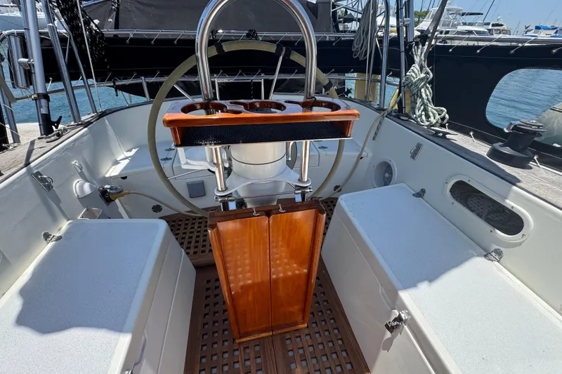 Slide: The Image of Cockpit of 1989 Gulf Pilot House sailboat with wooden accents and steering wheel. - 17