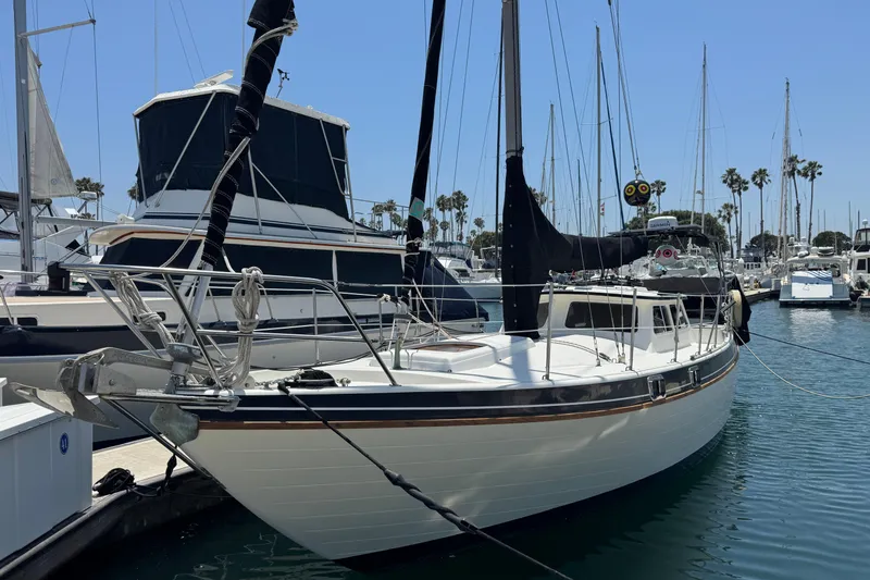 Slide: The Image of 1989 Gulf Pilot House sailboat docked in a marina with clear skies. - 2