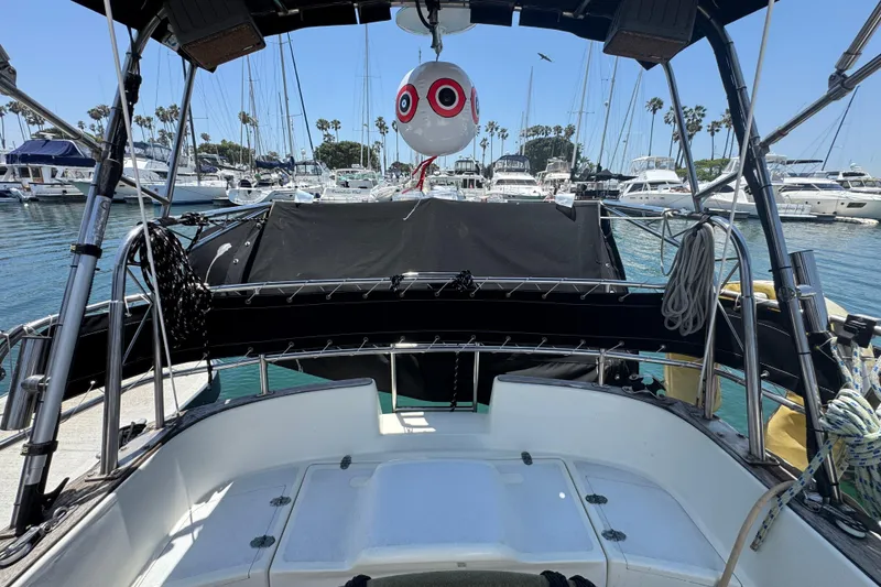 Slide: The Image of 1989 Gulf Pilot House boat cockpit view in marina with sailboats and palm trees. - 21