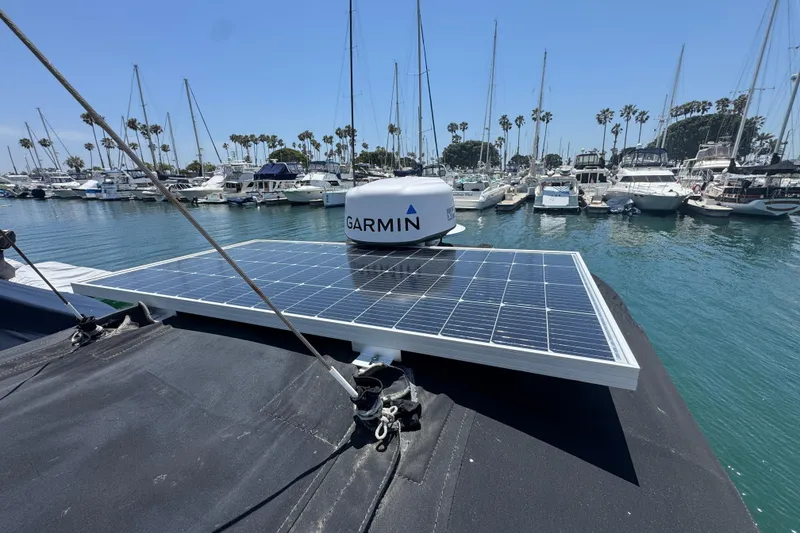 Slide: The Image of 1989 Gulf Pilot House with solar panel and Garmin radar in a marina. - 24
