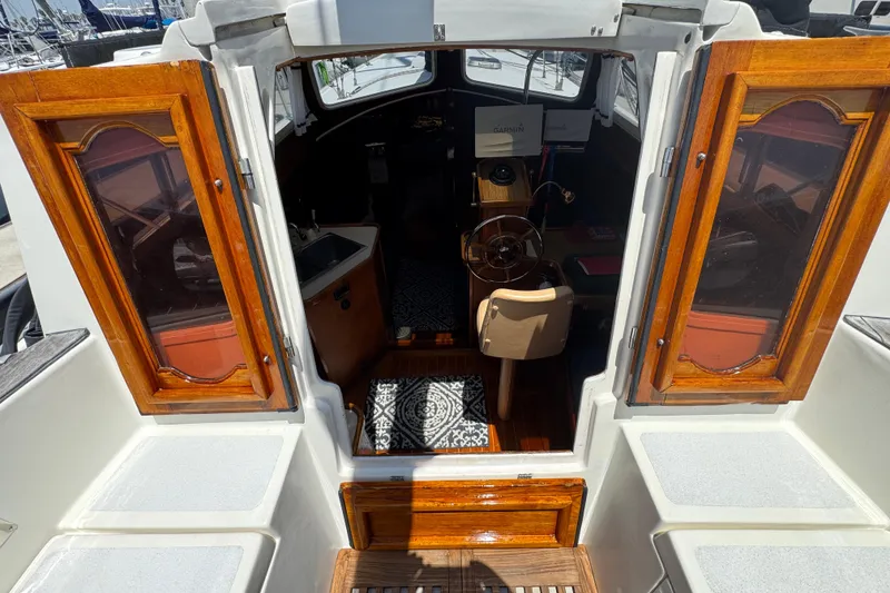 Slide: The Image of 1989 Gulf Pilot House interior with wooden doors and nautical equipment. - 27