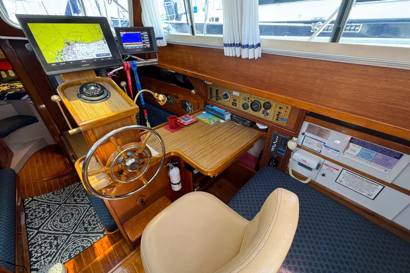 Slide: The Image of 1989 Gulf Pilot House interior with navigation equipment and wooden steering wheel. - 32