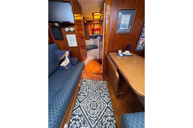 Slide: The Image of Interior of 1989 Gulf Pilot House boat with cozy seating and nautical decor. - 37