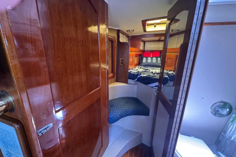 Slide: The Image of Cozy cabin interior of a 1989 Gulf Pilot House boat with wooden finishes and a comfortable bed. - 42