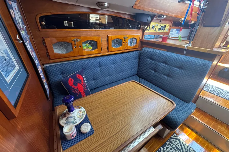 Slide: The Image of Cozy 1989 Gulf Pilot House interior with blue seating and wooden accents. - 46