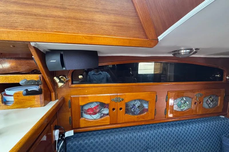 Slide: The Image of 1989 Gulf Pilot House interior with wooden cabinets, stained glass, and Bose speaker. - 51