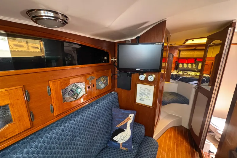 Slide: The Image of Interior of a 1989 Gulf Pilot House boat with cozy seating and nautical decor. - 52