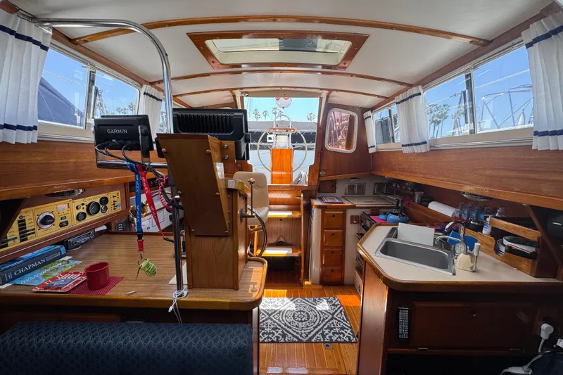 Slide: The Image of Interior of a 1989 Gulf Pilot House boat with wooden finishes and nautical equipment. - 53