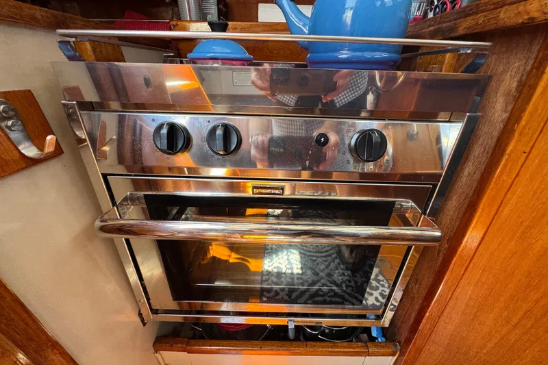 Slide: The Image of Stainless steel oven in 1989 Gulf Pilot House kitchen with blue kettle on top. - 56