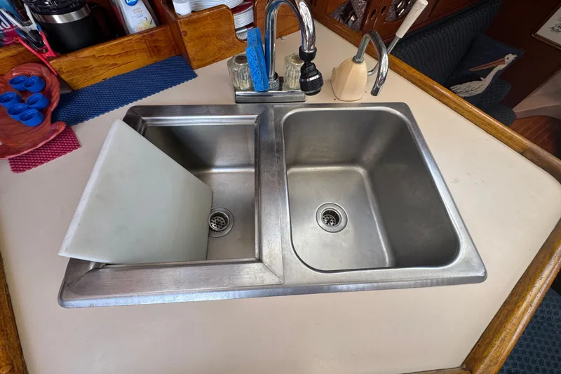 Slide: The Image of Stainless steel double sink in 1989 Gulf Pilot House kitchen with faucet and cutting board. - 57