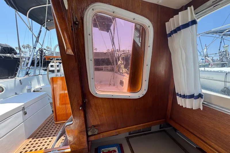 Slide: The Image of Interior view of 1989 Gulf Pilot House boat with wooden paneling and nautical decor. - 58