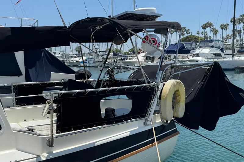 Slide: The Image of 1989 Gulf Pilot House boat docked in marina with other vessels. - 6