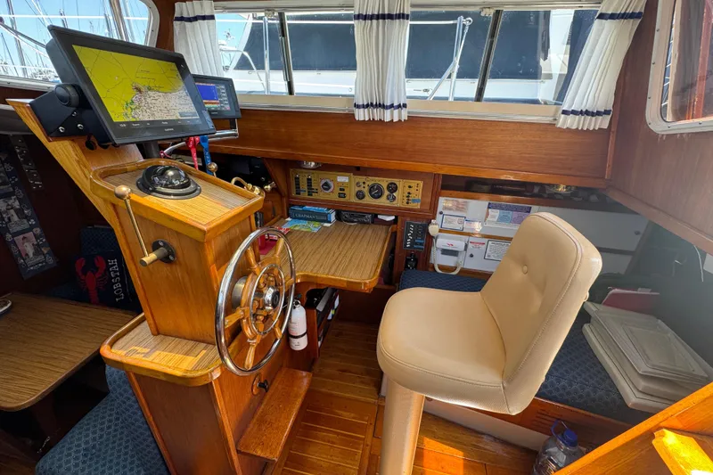 Slide: The Image of 1989 Gulf Pilot House interior with navigation equipment and captain's chair. - 60