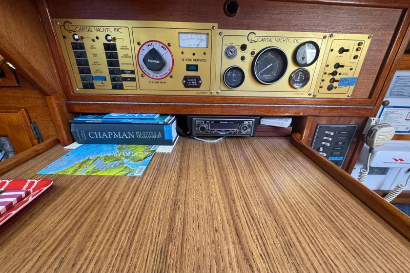 Slide: The Image of Control panel of a 1989 Gulf Pilot House boat with navigation books and equipment. - 63