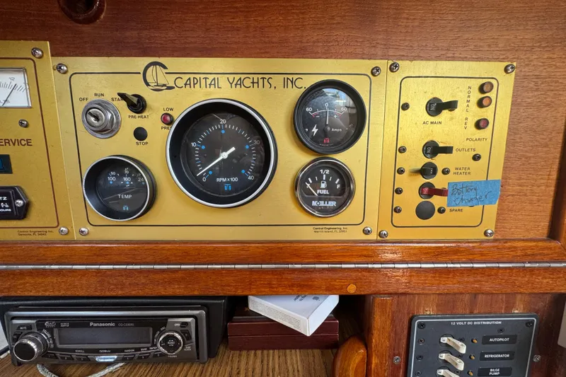 Slide: The Image of Control panel of a 1989 Gulf Pilot House yacht with gauges and switches. - 65