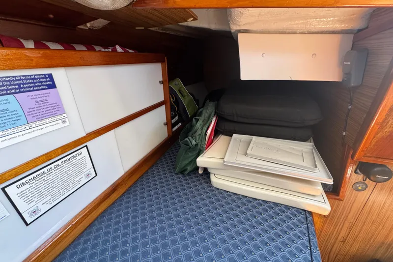 Slide: The Image of Interior cabin of a 1989 Gulf Pilot House boat with storage and cushions. - 68