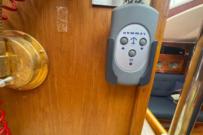Slide: The Image of Remote control on wooden panel inside 1989 Gulf Pilot House boat cabin. - 69