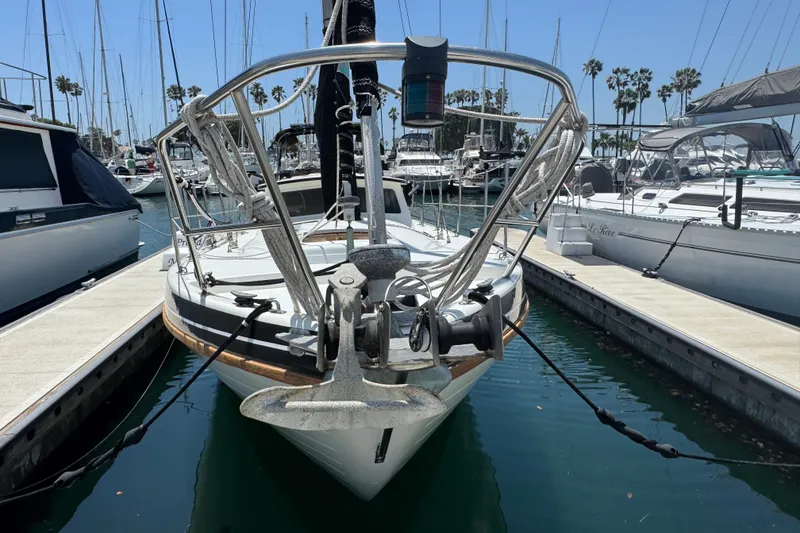Slide: The Image of 1989 Gulf Pilot House sailboat docked in a marina, surrounded by other boats. - 7