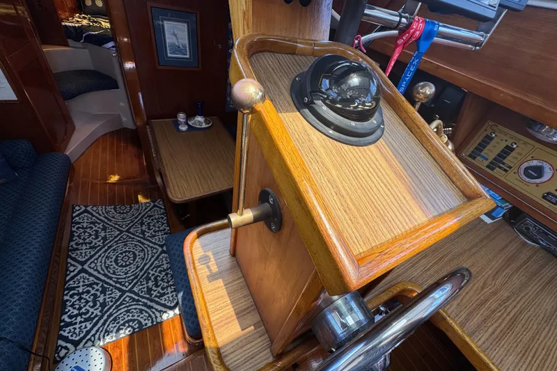 Slide: The Image of Interior of 1989 Gulf Pilot House boat with wooden helm and nautical decor. - 71
