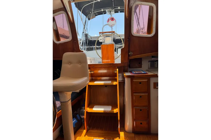 Slide: The Image of Interior view of 1989 Gulf Pilot House boat, featuring wooden steps and seating. - 76