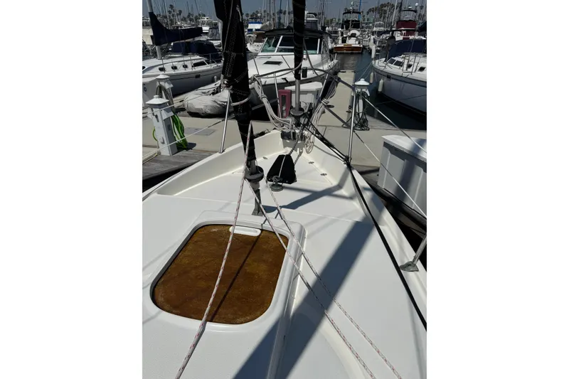 Slide: The Image of 1989 Gulf Pilot House sailboat deck with rigging in marina setting. - 8