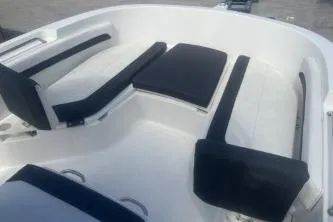 Slide: The Image of 2023 Trophy T22 boat interior with cushioned seating and sleek design. - 11