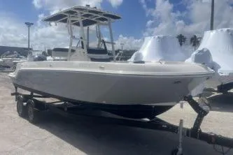Slide: The Image of 2023 Trophy T22 boat on trailer under a partly cloudy sky. - 4