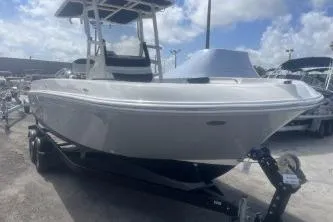 Slide: The Image of 2023 Trophy T22 boat on trailer under a partly cloudy sky. - 6