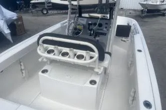 Slide: The Image of 2023 Trophy T22 boat interior with seating and control panel, docked outdoors. - 9
