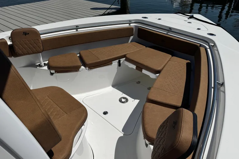 Slide: The Image of 2024 Sea Pro 239 Deep V CC boat with brown cushioned seating in the bow area. - 104