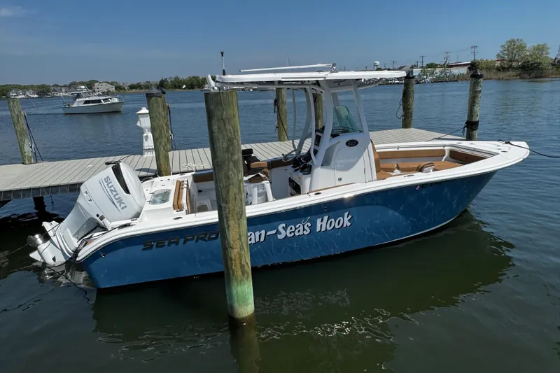 The Image of 2024 Sea Pro 239 Deep V CC boat docked, featuring Suzuki outboard motor. - 43