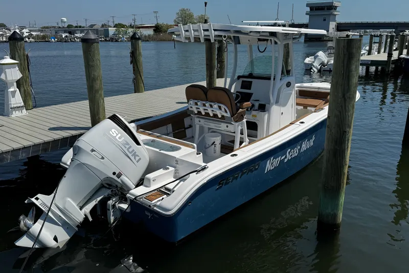 Slide: The Image of 2024 Sea Pro 239 Deep V CC boat docked with Suzuki outboard motor. - 46