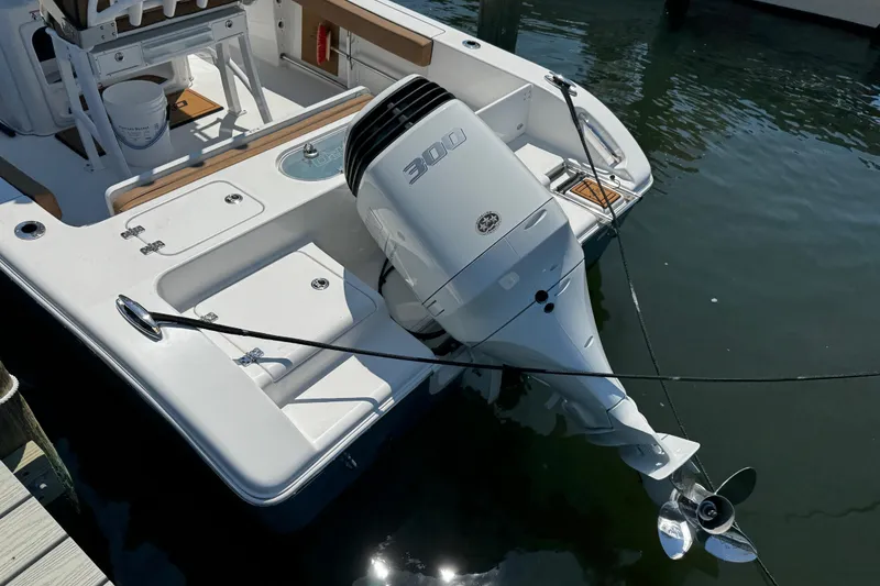 Slide: The Image of 2024 Sea Pro 239 Deep V CC boat with powerful 300 HP outboard engine docked in water. - 48