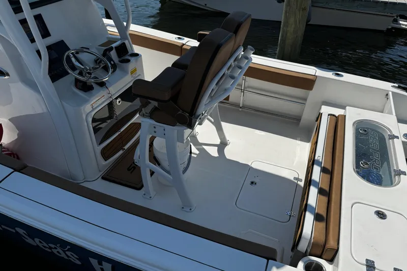 Slide: The Image of 2024 Sea Pro 239 Deep V CC boat interior with helm, seating, and storage compartments. - 51