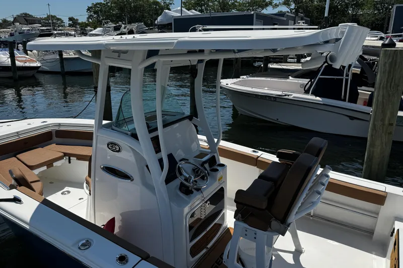 Slide: The Image of 2024 Sea Pro 239 Deep V CC boat docked at marina, featuring sleek design and spacious seating. - 53