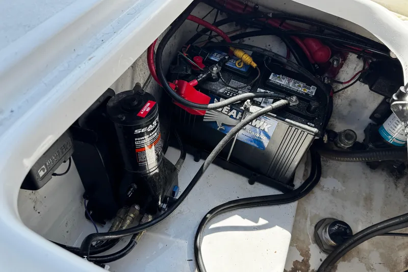 Slide: The Image of 2024 Sea Pro 239 Deep V CC boat battery compartment with wiring and components. - 56