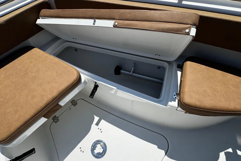 Slide: The Image of 2024 Sea Pro 239 Deep V CC boat interior with brown cushioned seating and storage compartment. - 59