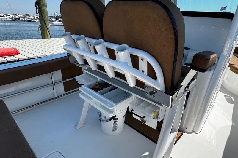 Slide: The Image of 2024 Sea Pro 239 Deep V CC boat interior with rod holders and storage compartments. - 63